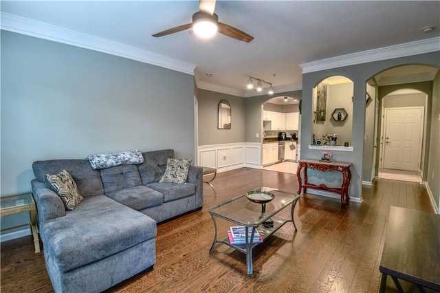 living room featuring ceiling fan, dark hardwood / wood-style floors, and crown molding