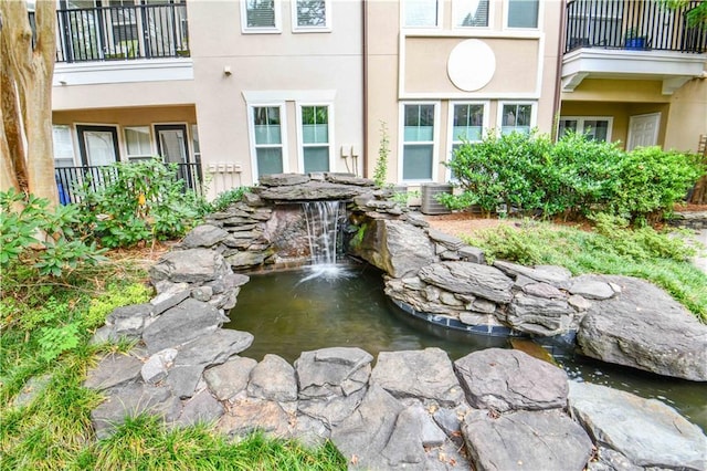 view of community with a garden pond