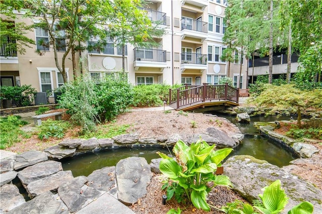 view of community featuring a small pond