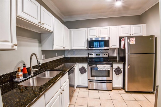 kitchen with ornamental molding, sink, stainless steel appliances, and white cabinets