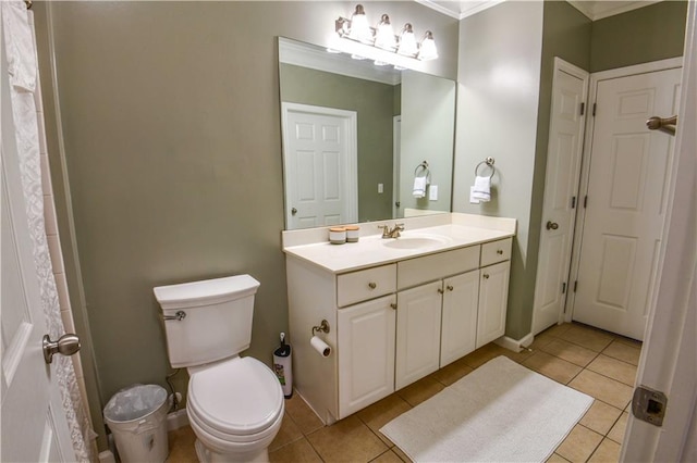 bathroom featuring ornamental molding, vanity, toilet, and tile patterned floors