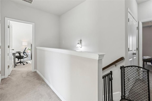 hallway with light colored carpet