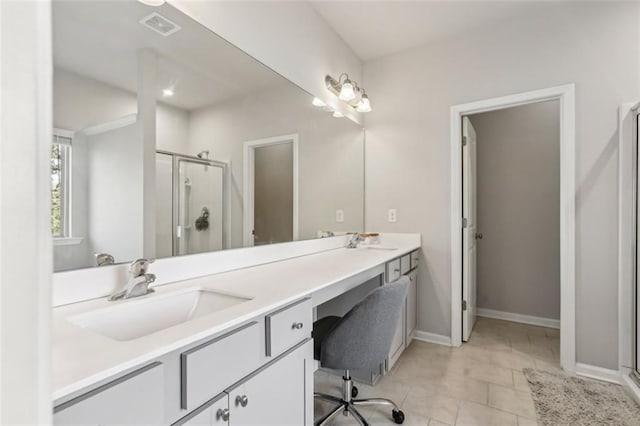 bathroom with a shower with door, vanity, and tile patterned flooring