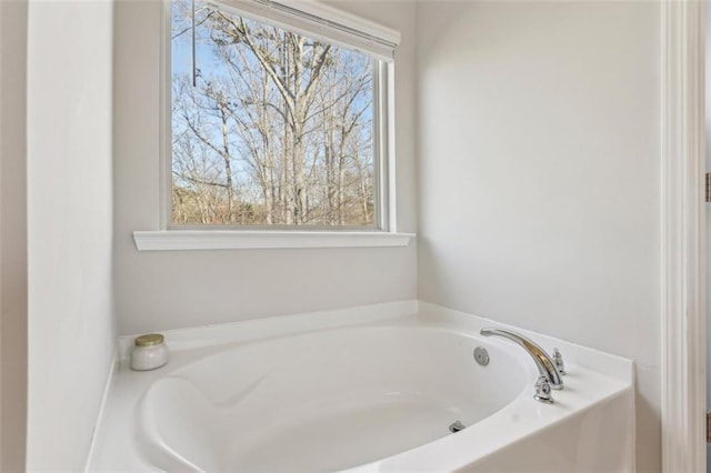 bathroom featuring a bathing tub and a wealth of natural light