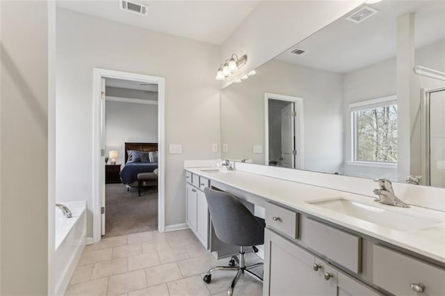 bathroom featuring tile patterned floors, vanity, and shower with separate bathtub