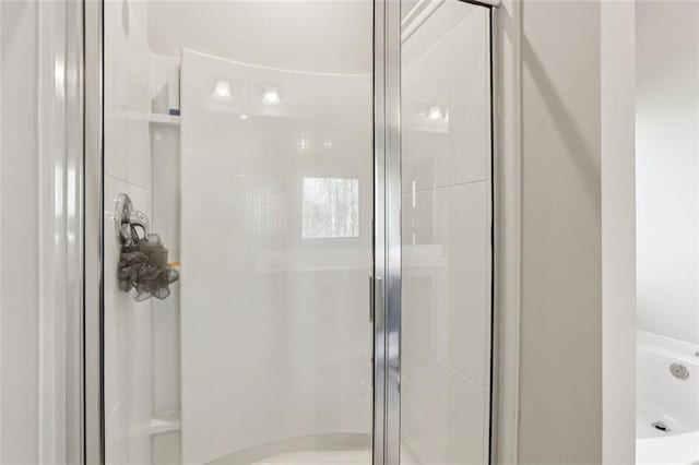 bathroom with a shower with door