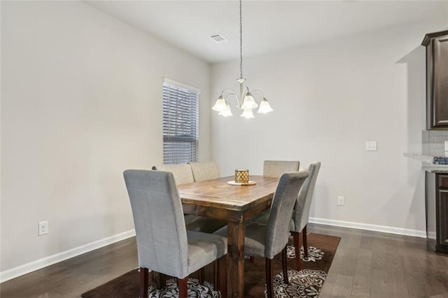 dining space featuring a notable chandelier and dark hardwood / wood-style flooring