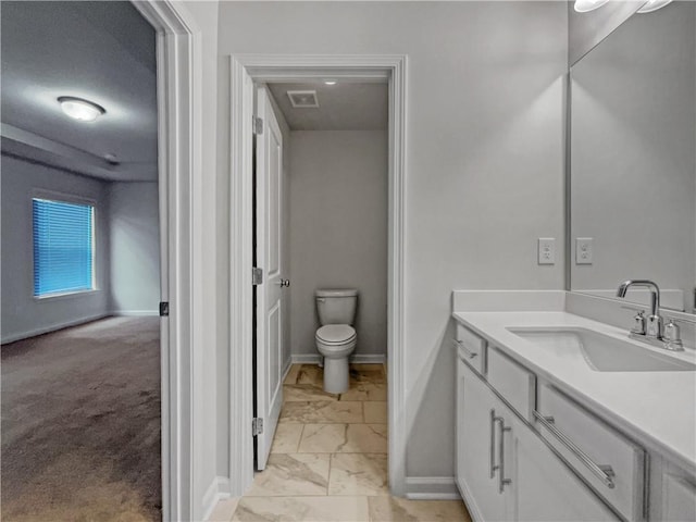 bathroom featuring toilet and vanity