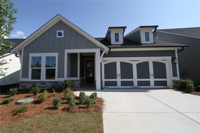 2040 Ripple Park Bnd, Canton, GA 30114 - view of front of property with concrete driveway, an attached garage, board and batten siding, and stone siding