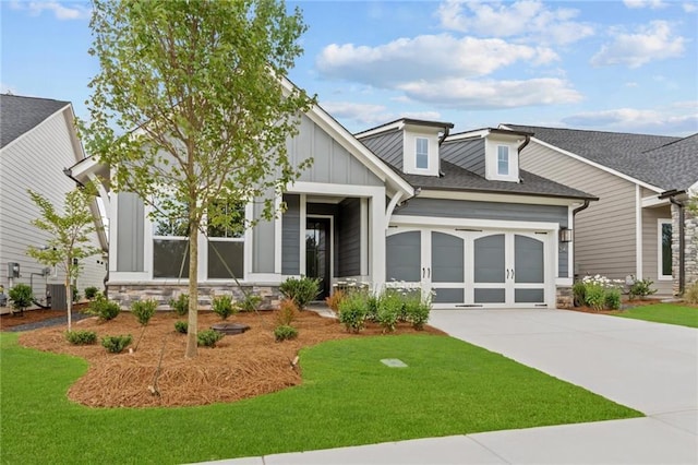 2040 Ripple Park Bnd, Canton, GA 30114 - view of front of house featuring board and batten siding, a garage, stone siding, driveway, and a front lawn