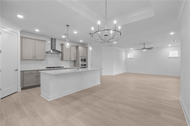 2040 Ripple Park Bnd, Canton, GA 30114 - kitchen with gray cabinets, wall chimney exhaust hood, light countertops, a chandelier, and ceiling fan