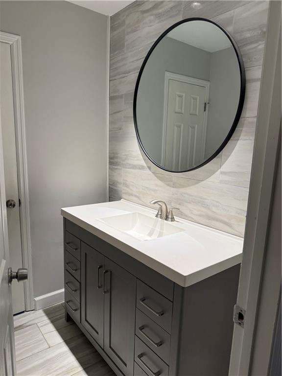 184 Wana Cir SE, Mableton, GA 30126 - bathroom with tile walls, vanity, and tasteful backsplash