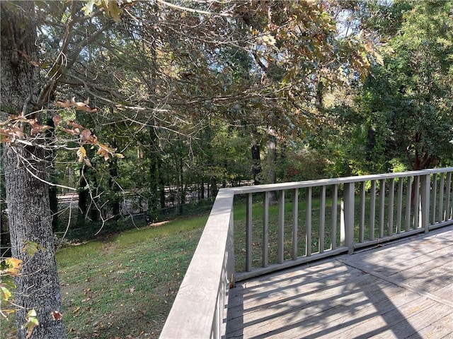 wooden deck with a lawn