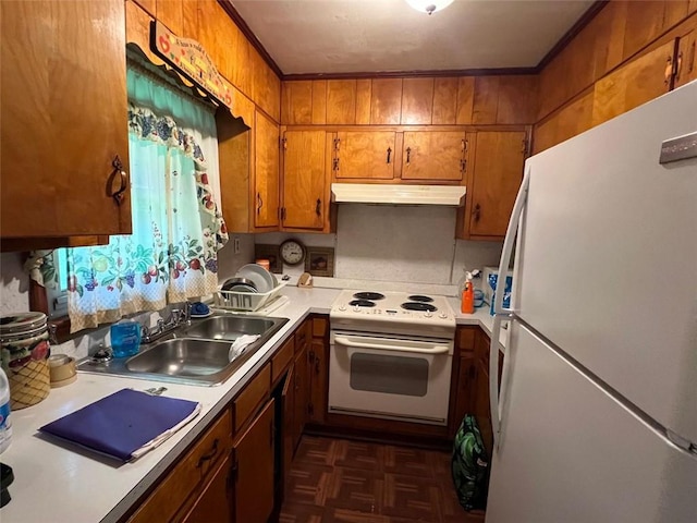 kitchen featuring white appliances, brown cabinetry, under cabinet range hood, light countertops, and a sink