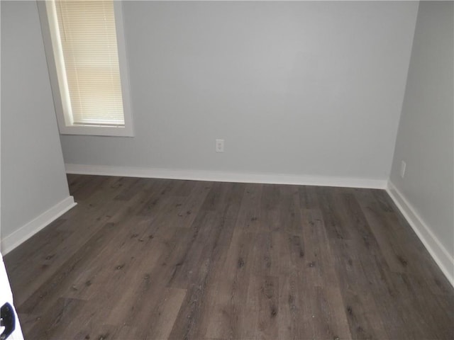 unfurnished room featuring dark wood-type flooring