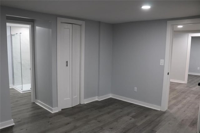 unfurnished bedroom with dark hardwood / wood-style floors and a closet