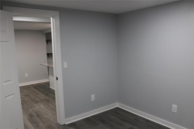 unfurnished room with dark hardwood / wood-style floors