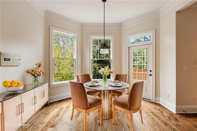 dining area featuring light hardwood / wood-style flooring and ornamental molding