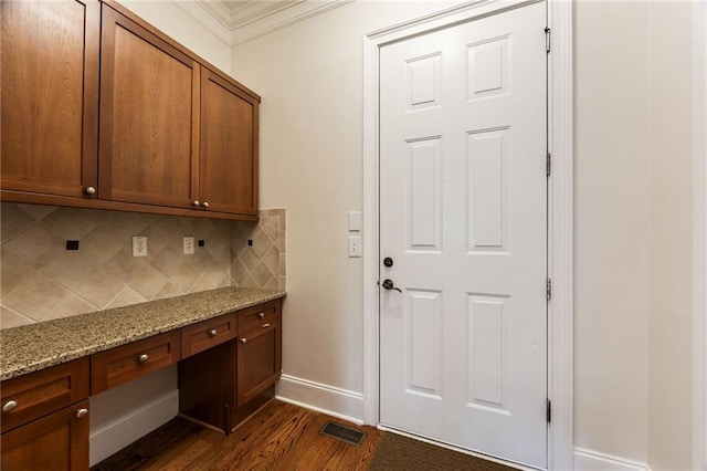 interior space with dark wood-type flooring and crown molding