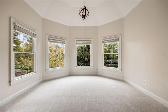 interior space with carpet, a chandelier, and lofted ceiling