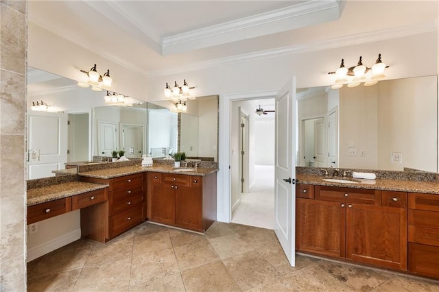 bathroom featuring ceiling fan, ornamental molding, vanity, and a tray ceiling