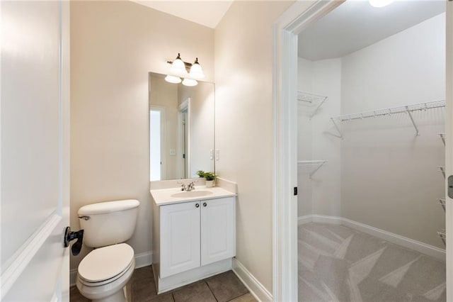 bathroom with tile patterned flooring, vanity, and toilet