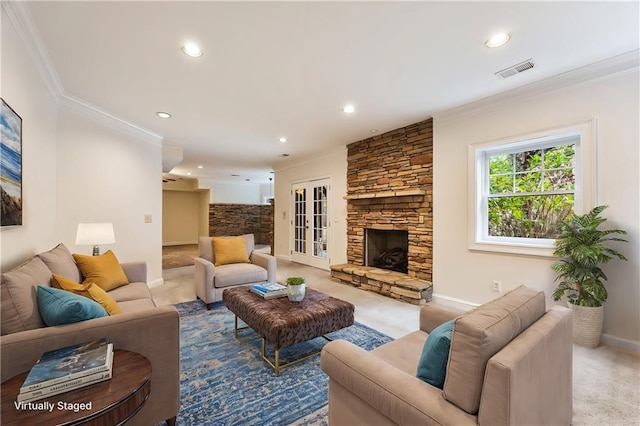 living room with ornamental molding, a fireplace, light carpet, and french doors