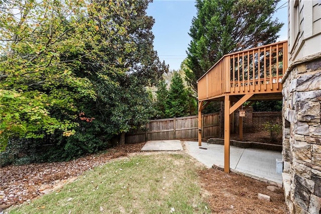 view of yard with a wooden deck and a patio