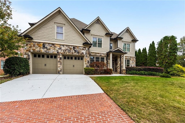 craftsman-style house featuring a garage and a front yard