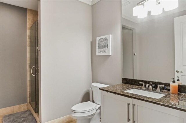 bathroom featuring tile patterned flooring, vanity, toilet, and walk in shower