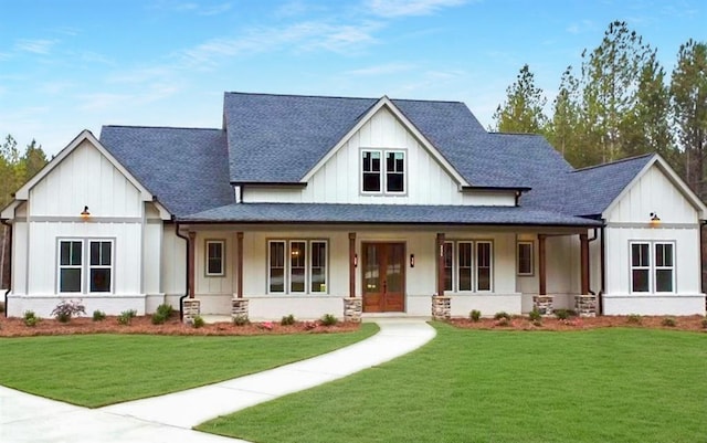 modern farmhouse style home featuring a front lawn and a porch