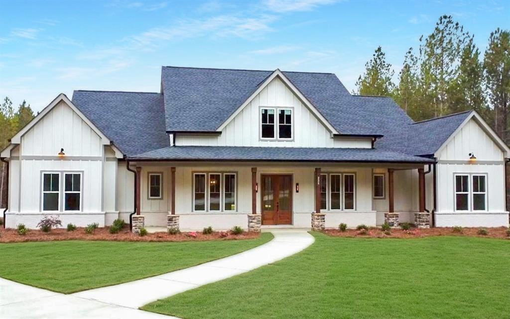 modern farmhouse featuring roof with shingles, french doors, a porch, board and batten siding, and a front yard