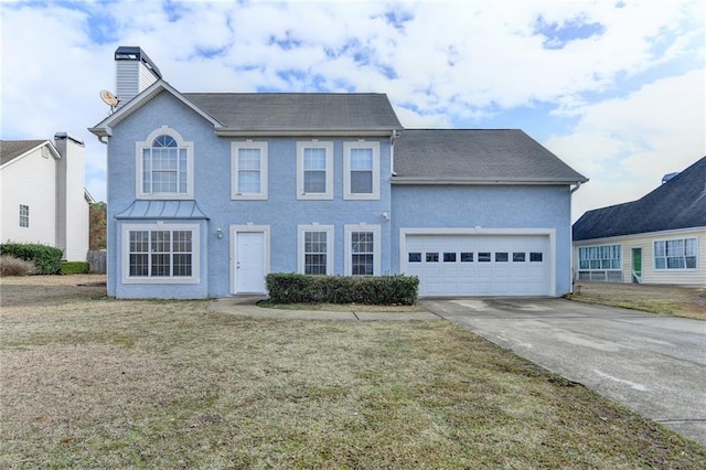 view of front of house featuring a garage and a front lawn