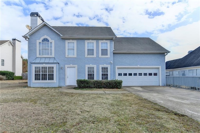 view of front of house with a garage and a front lawn