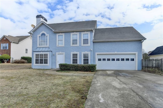 view of front of property featuring a garage and a front yard