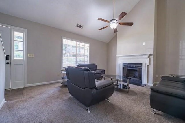 living room with a fireplace, carpet, visible vents, and baseboards