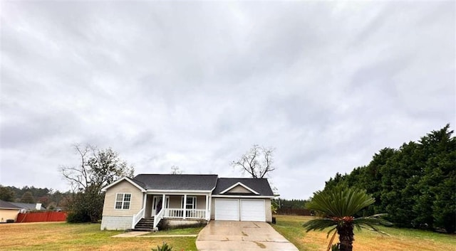 ranch-style home featuring an attached garage, a front lawn, fence, covered porch, and driveway