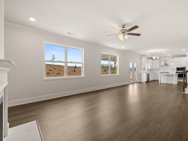 64 Parkview Dr, Dallas, GA 30157 - unfurnished living room featuring ceiling fan with notable chandelier, dark wood-type flooring, and ornamental molding