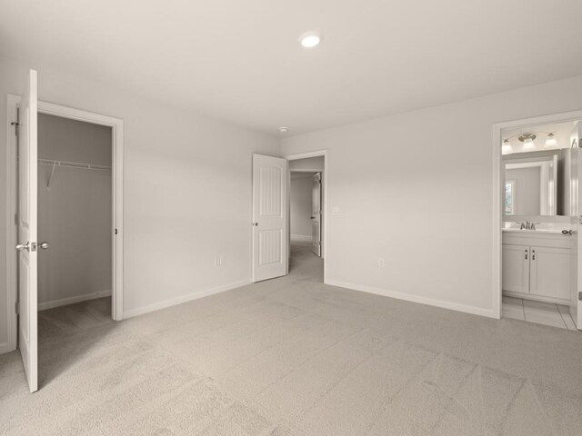 64 Parkview Dr, Dallas, GA 30157 - unfurnished bedroom with connected bathroom, a closet, light colored carpet, a walk in closet, and sink