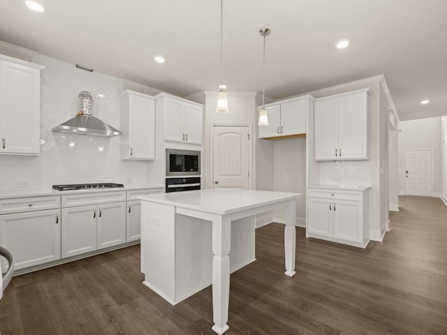 64 Parkview Dr, Dallas, GA 30157 - kitchen with decorative light fixtures, decorative backsplash, white cabinetry, built in microwave, and wall chimney exhaust hood
