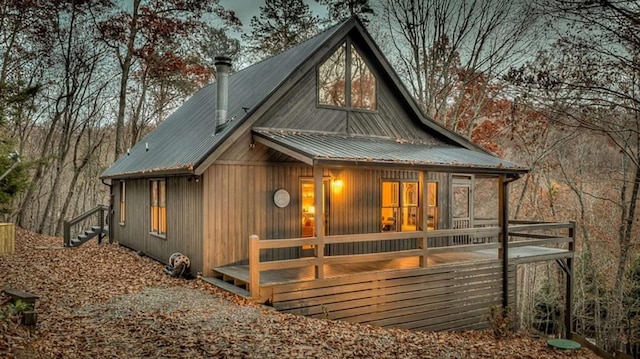 back of house featuring metal roof