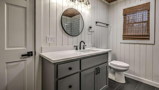 bathroom featuring tile patterned floors, toilet, and vanity