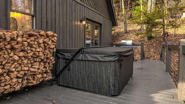 wooden terrace with a grill and a hot tub