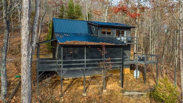 back of property featuring metal roof and a sunroom