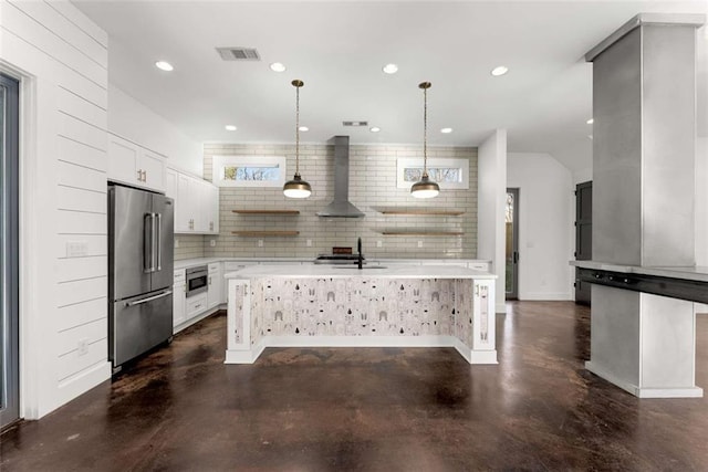 kitchen with visible vents, light countertops, high quality fridge, wall chimney exhaust hood, and open shelves