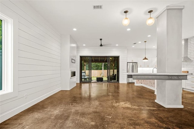 244 Locust St NE Unit B, Atlanta, GA 30317 - unfurnished living room with finished concrete floors and recessed lighting