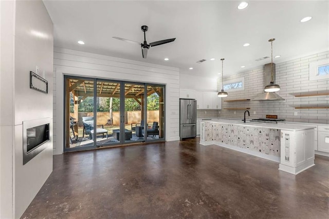 unfurnished living room featuring visible vents, a sink, recessed lighting, concrete floors, and ceiling fan