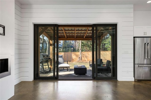 entryway with finished concrete floors and a fireplace