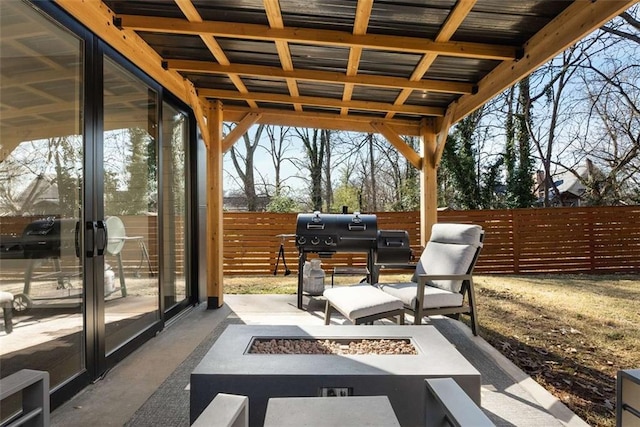 view of patio featuring fence and an outdoor fire pit