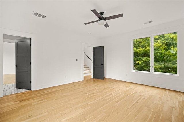 244 Locust St NE Unit B, Atlanta, GA 30317 - empty room featuring light wood finished floors, stairway, baseboards, and a ceiling fan